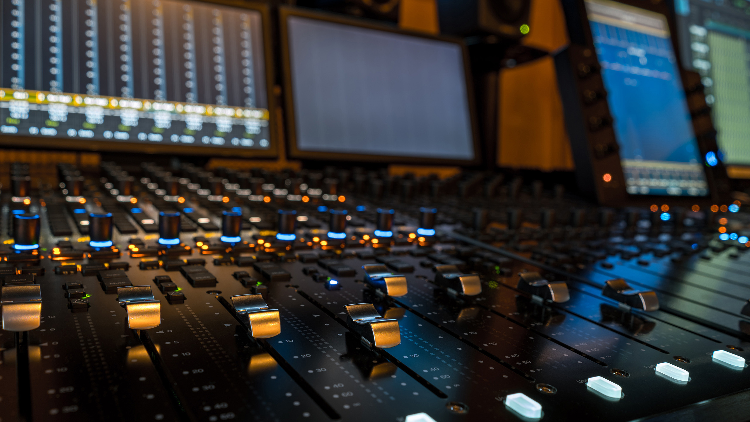 Close-up of an Avid S6 control surface in a professional audio mixing environment