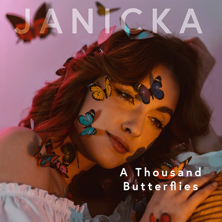 Cover of Janicka’s “A Thousand Butterflies” with a portrait of Janicka with butterflies on her face